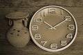 Circle clock and old jar at the wall