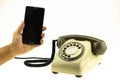 Vintage picture style of New smart phone with old telephone on white background. New communication technology Royalty Free Stock Photo