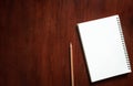 Blank notebook with brown pencil on wooden table