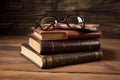 vintage pile of five old brown leather books with eye glasses on a wood table2