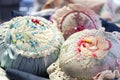 Vintage pin cushions with colorful needles and pins, soft focus