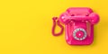 Vintage pink telephone on yellow background Royalty Free Stock Photo