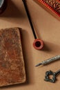 A vintage pipe and an old notebook, retro objects. The concept of a journalist