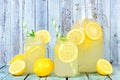 Vintage pitcher of lemonade with mason jar glasses on rustic blue wood Royalty Free Stock Photo