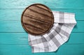 Vintage plaid tablecloth and brown cutting board for pizza on blue wooden table. Wood background. Top view and mock up Royalty Free Stock Photo
