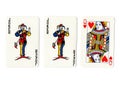 Vintage playing cards showing a pair of pair of jokers and a queen.