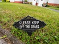 A vintage `Please keep off the grass` sign. Royalty Free Stock Photo