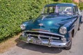 Vintage Plymouth car parked up down a quiet road in Norfolk