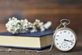 Vintage pocket watch, book and spring flowers Royalty Free Stock Photo