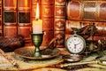 Pocket watch, burning candle and old books Royalty Free Stock Photo