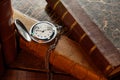 Vintage pocket watch with chain and antique books on a wooden table close-up Royalty Free Stock Photo