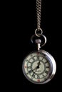vintage pocket watch on a chain of bronze color close-up on a black background Royalty Free Stock Photo