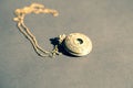 Vintage pocket watch with constelation design on cover shoot in a summer day closeup. Selective Focus