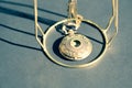 Vintage pocket watch with constelation design on cover shoot in a summer day closeup. Selective Focus