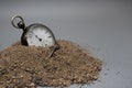 Vintage pocket watch falling over on pile of sand Royalty Free Stock Photo