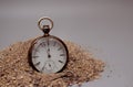 Vintage pocket watch vertical on pile of sand Royalty Free Stock Photo
