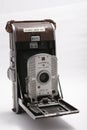 Vintage polaroid camera against a white background