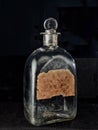 Vintage pontil type bottle on dark backdrop studio shot Lokgram