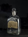 Vintage pontil type bottle on dark backdrop studio shot Lokgram