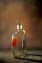 Vintage pontil type bottle on rustic backdrop studio shot Lokgram
