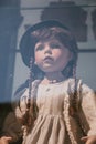 Vintage porcelain baby dolls in simple clothes in a shop window, selective focus