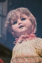 Vintage porcelain baby dolls in simple clothes in a shop window, selective focus Royalty Free Stock Photo