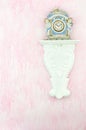 Vintage porcelain clock against a pink background. Copy space. Royalty Free Stock Photo