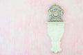 Vintage porcelain clock against a pink background. Copy space. Royalty Free Stock Photo