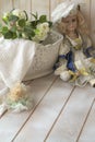 Vintage porcelain doll in the shabby background. Porcelain doll in vintage interior Royalty Free Stock Photo