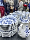 vintage porcelain plates and pot in a flea market