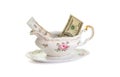 Vintage porcelain sauce-boat with dollar bills Royalty Free Stock Photo