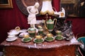 Vintage porcelain tea sets and interior items on an old chest of drawers Royalty Free Stock Photo