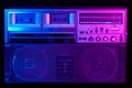 Vintage portable stereo boombox cassette recorder from 80s with reflection of blue and pink neon light