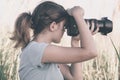 Vintage portrait of a beautiful young woman who likes to take pictures of nature