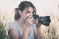 Vintage portrait of a beautiful young woman who likes to take pictures of nature