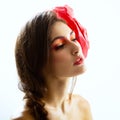 Vintage portrait of fashion glamour girl with red flower in her hair, over white. Royalty Free Stock Photo