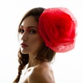 Vintage portrait of fashion glamour girl with red flower in her hair, studio shot. Royalty Free Stock Photo