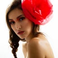 Vintage portrait of fashion glamour girl with red flower in her hair, studio shot. Royalty Free Stock Photo