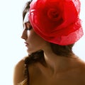 Vintage portrait of fashion glamour girl with red flower in her hair, studio shot. Royalty Free Stock Photo