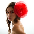 Vintage portrait of fashion glamour girl with red flower in her hair, studio shot Royalty Free Stock Photo