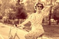 Vintage portrait of a girl with bike Royalty Free Stock Photo