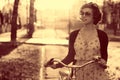 Vintage portrait of a girl with bike Royalty Free Stock Photo