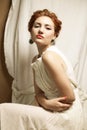 Vintage portrait of glamourous queen like girl in bedroom Royalty Free Stock Photo