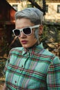 Vintage Portrait of tattooed blonde Female with Dress and Sunglasses