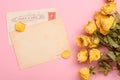 Vintage post cards with dry yellow roses flowers on pastel rose background