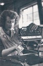 Vintage postcard of woman assembling typewriter at British Olivetti, 1955