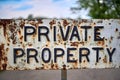 Vintage private property sign. Metallic and rusty. Close up Royalty Free Stock Photo