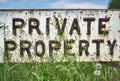 Vintage private property sign in the spring meadow. Close up Royalty Free Stock Photo