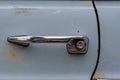 Vintage push button door styled handle on a light blue car
