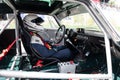 Vintage race car cockpit and dashboard, old Alfa Romeo with driver in racing suit Royalty Free Stock Photo